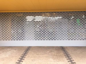 punched and glazed aluminium roller shutter front view