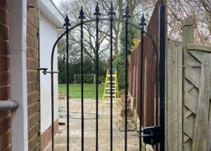 solid-steel garden gate to side