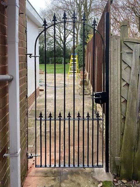 solid-steel garden gate to side